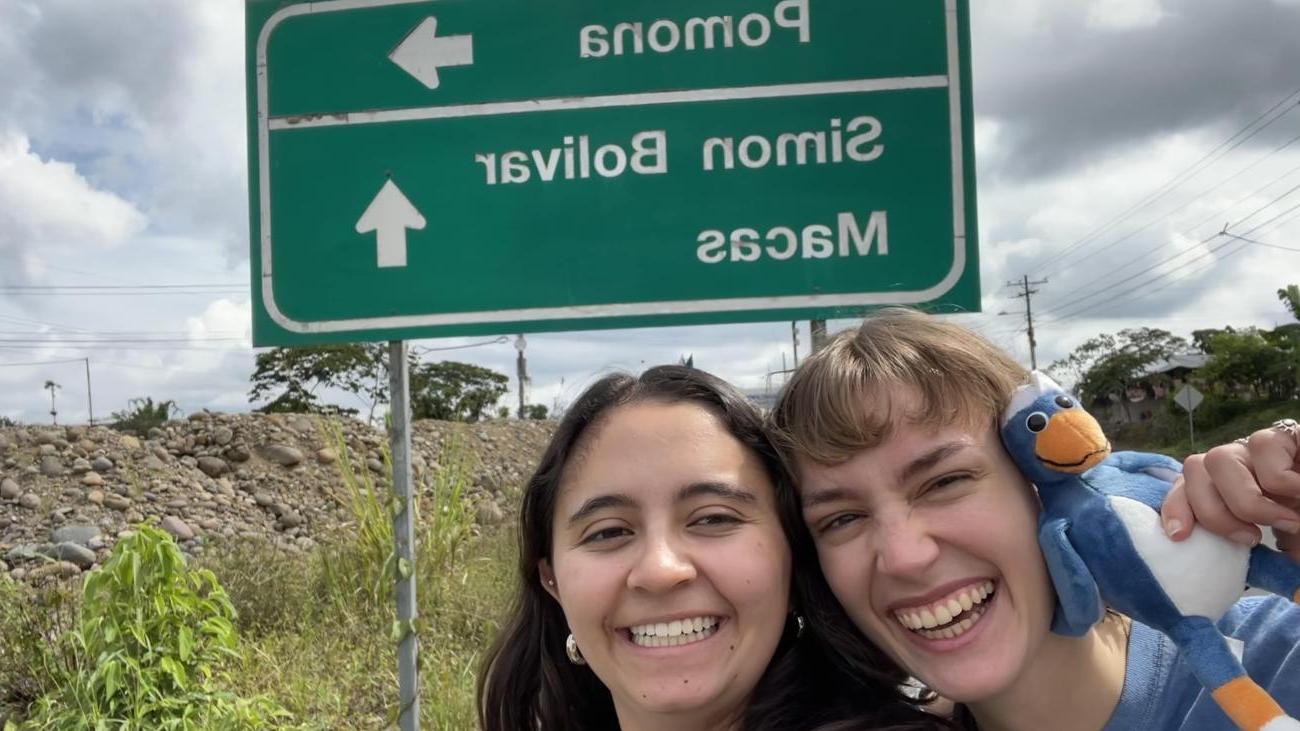 two students with Cecil in front of Pomona sign